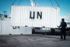 A civilian worker guides a UN container being unloaded from a ship during the multinational relief effort Operation Restore Hope